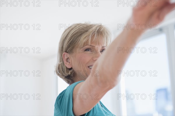 Older Caucasian woman with arms outstretched