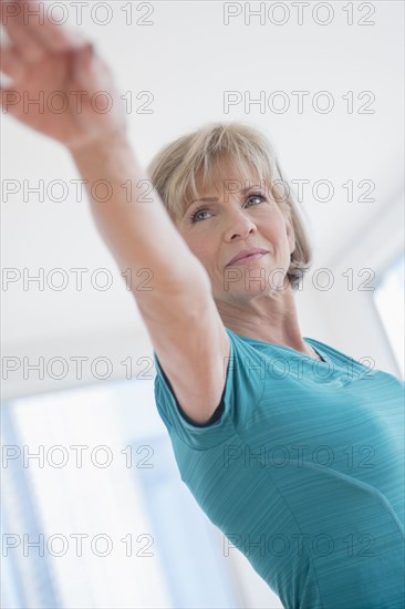 Older Caucasian woman with arms outstretched