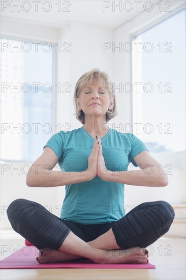 Older Caucasian woman meditating