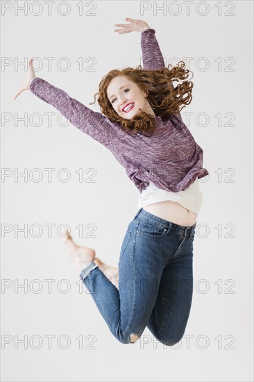 Caucasian woman jumping for joy