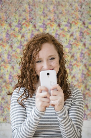 Caucasian woman taking cell phone selfie