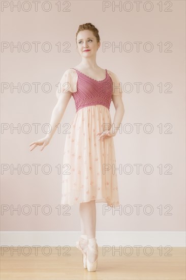 Caucasian ballerina standing en pointe