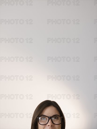 Face of Caucasian woman wearing eyeglasses looking up