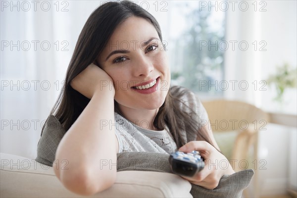 Caucasian woman aiming remote control