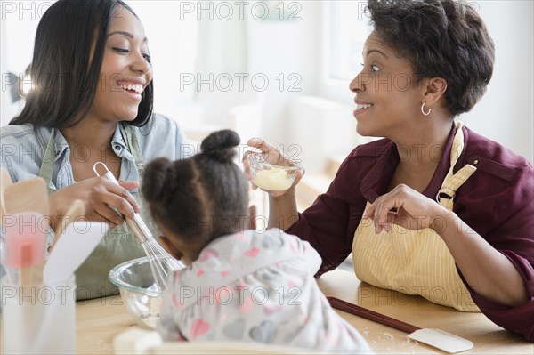 Black multi-generation family baking