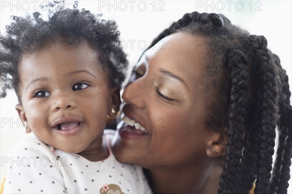 Close of  smiling Black woman and baby daughter