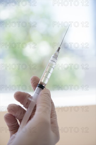 Hand holding syringe