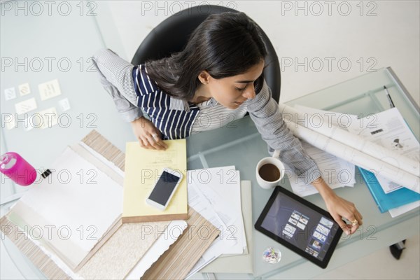 Indian businesswoman using digital tablet in office