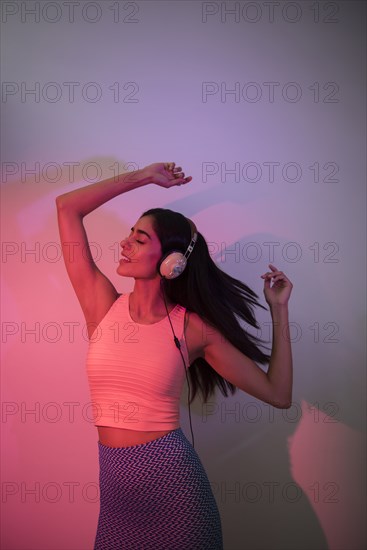 Indian woman dancing near wall casting shadow