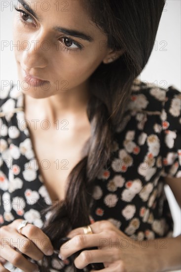 Indian woman braiding hair