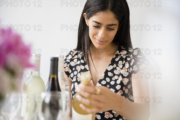 Indian woman choosing bottle of wine
