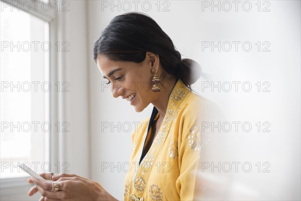 Indian woman texting with cell phone