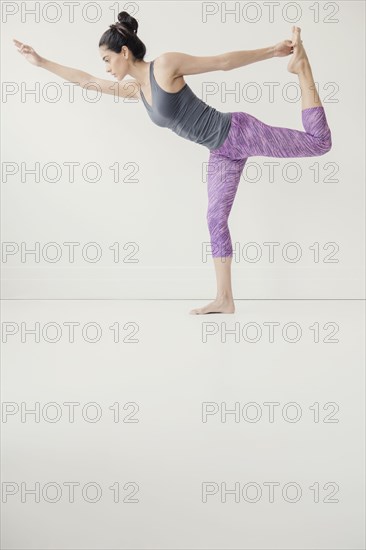 Indian woman holding foot in yoga pose