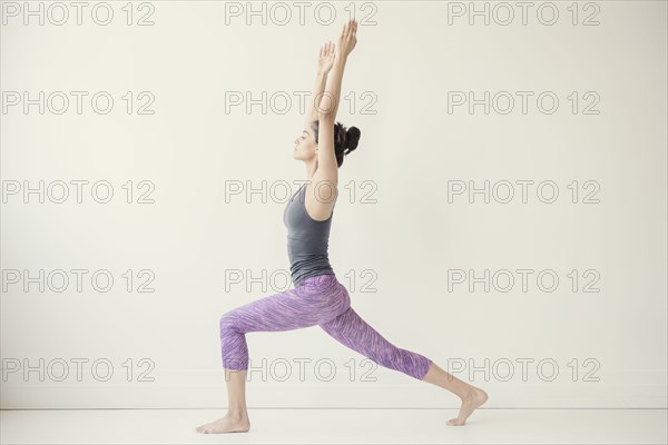 Indian woman with arms raised yoga pose