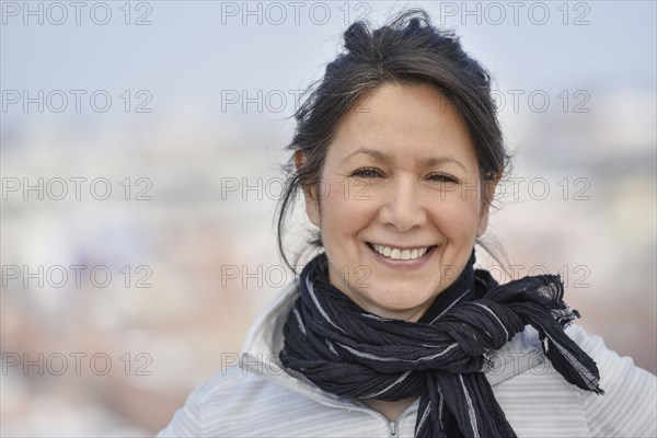 Smiling Hispanic woman wearing scarf