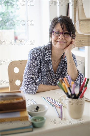Hispanic woman smiling in home office