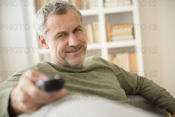 Older Caucasian man watching television
