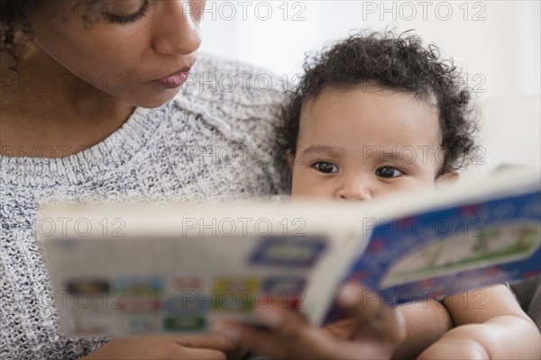 Mother reading book to baby son
