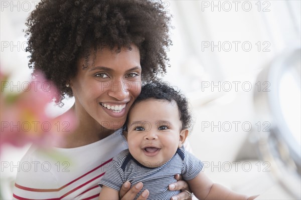 Smiling mother posing with baby son