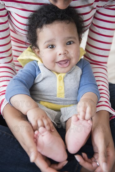 Mother holding baby son in lap