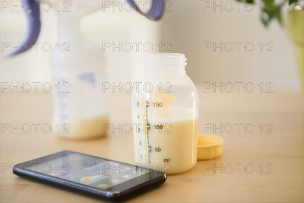 Cell phone near bottle of breast milk