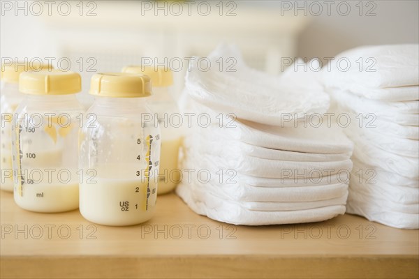 Bottles of breast milk and diapers