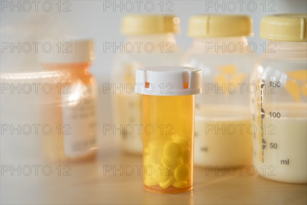 Bottle of prescription pills and bottles of breast milk