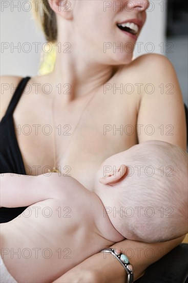 Caucasian mother breastfeeding baby son