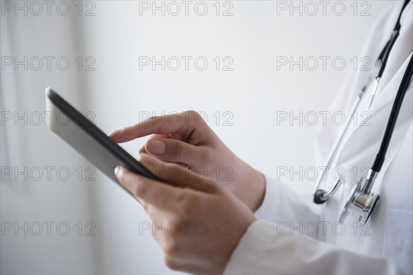 Hispanic doctor using digital tablet