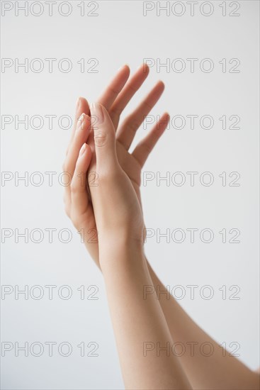 Hispanic woman rubbing hands