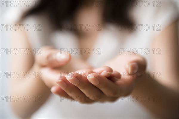 Hispanic woman cupping hands