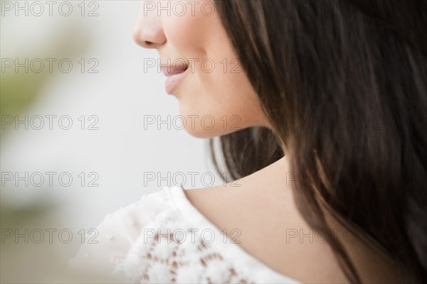 Hispanic woman smiling over shoulder