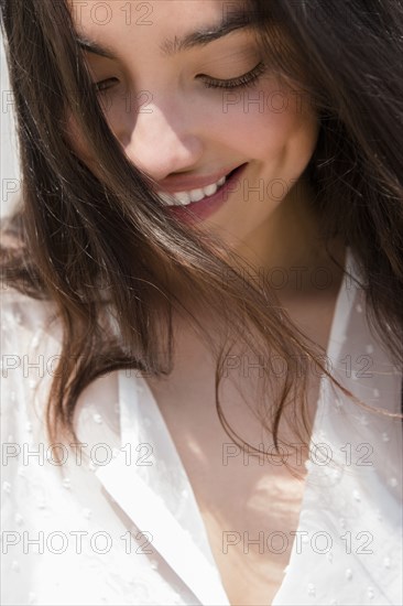 Hispanic woman smiling in wind