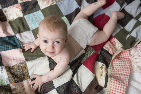 Caucasian boy laying on blanket looking up