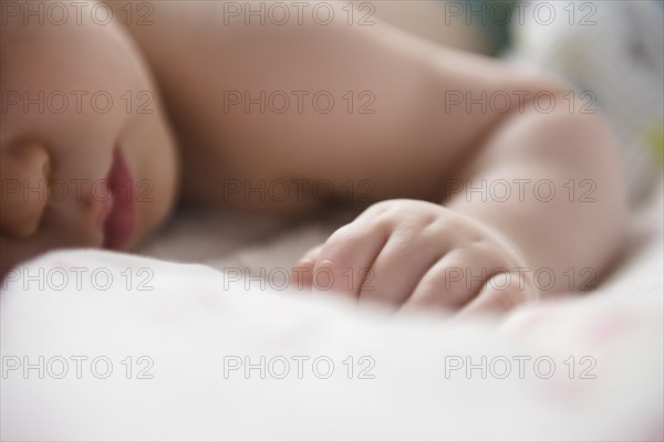 Caucasian baby boy sleeping on blanket