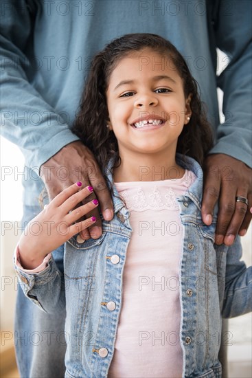 Smiling daughter posing with father