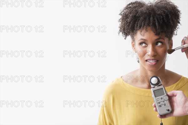 Makeup artist using makeup brush on woman