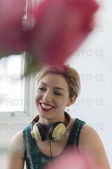 Caucasian woman with headphones around neck