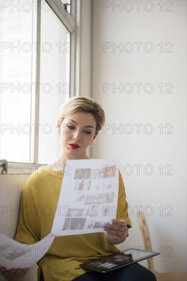 Caucasian woman examining paperwork