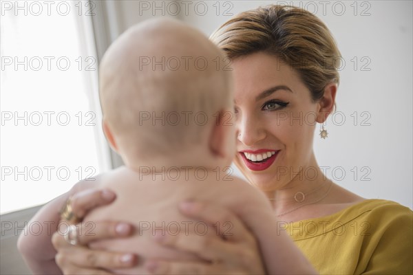 Caucasian woman holding baby boy