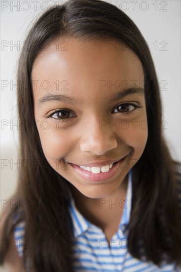 Close up of smiling Mixed Race girl