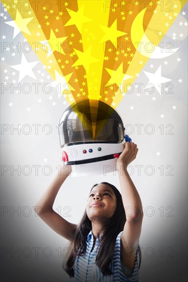 Mixed Race girl imagining being an astronaut