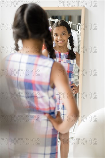 Reflection of Mixed Race girl in mirror