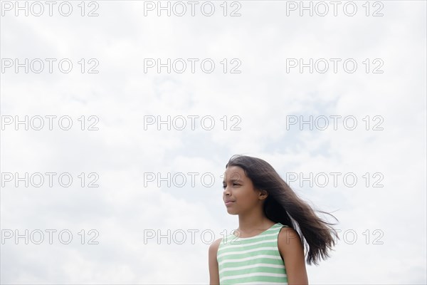 Wind blowing hair of serious Mixed Race girl