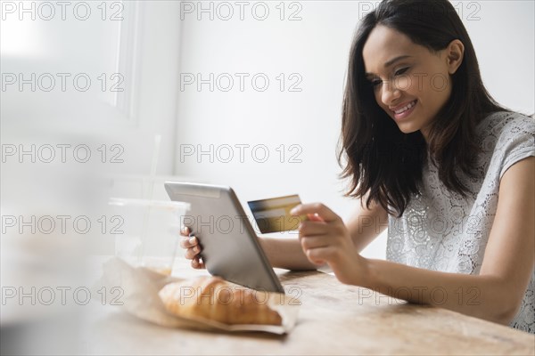 Mixed Race woman online shopping with credit card