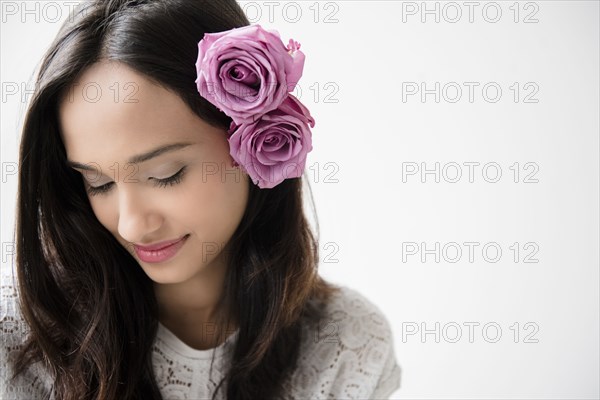 Mixed Race woman with roses in hair
