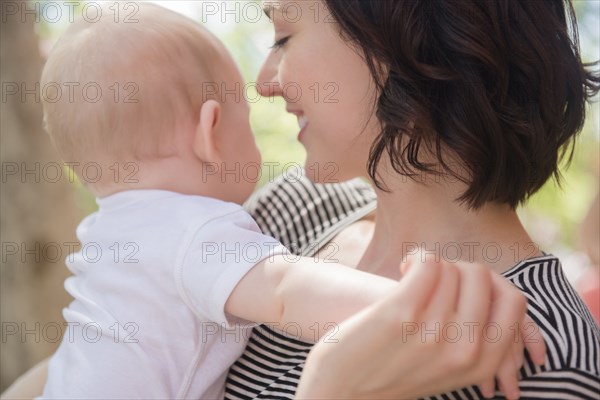 Caucasian mother holding baby son