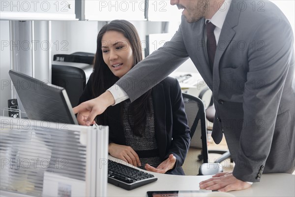 Business people talking in office using computer