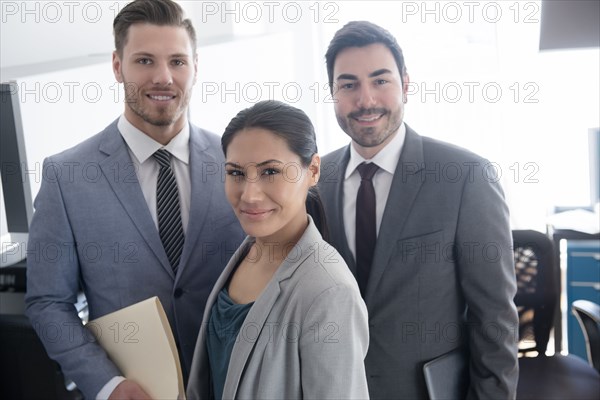 Smiling business people posing in office