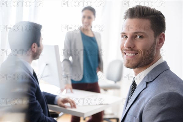 Portrait of smiling businessman in office